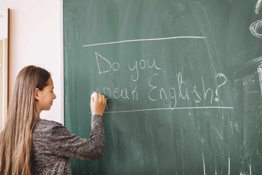 young-lady-writing-chalk-board